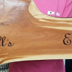 wood plank engraving with script