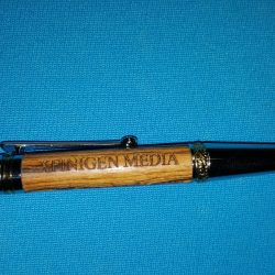 engraved wooden cylinder on a pen